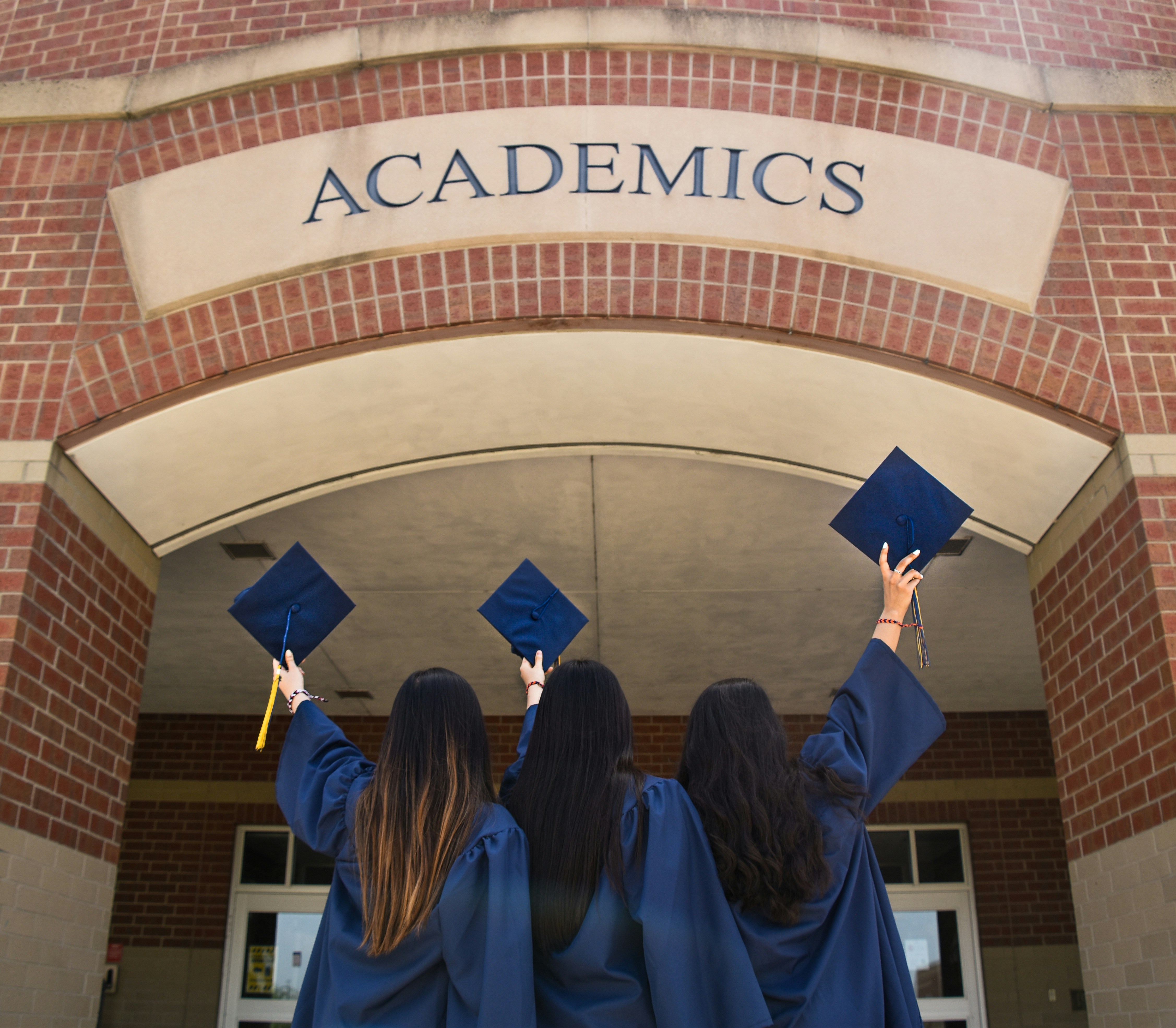 Graduates celebrating outside an academic building